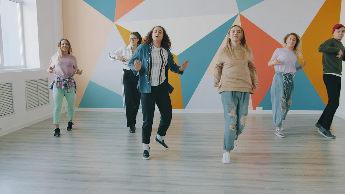 Group of colleagues dancing together energetically in a bright studio