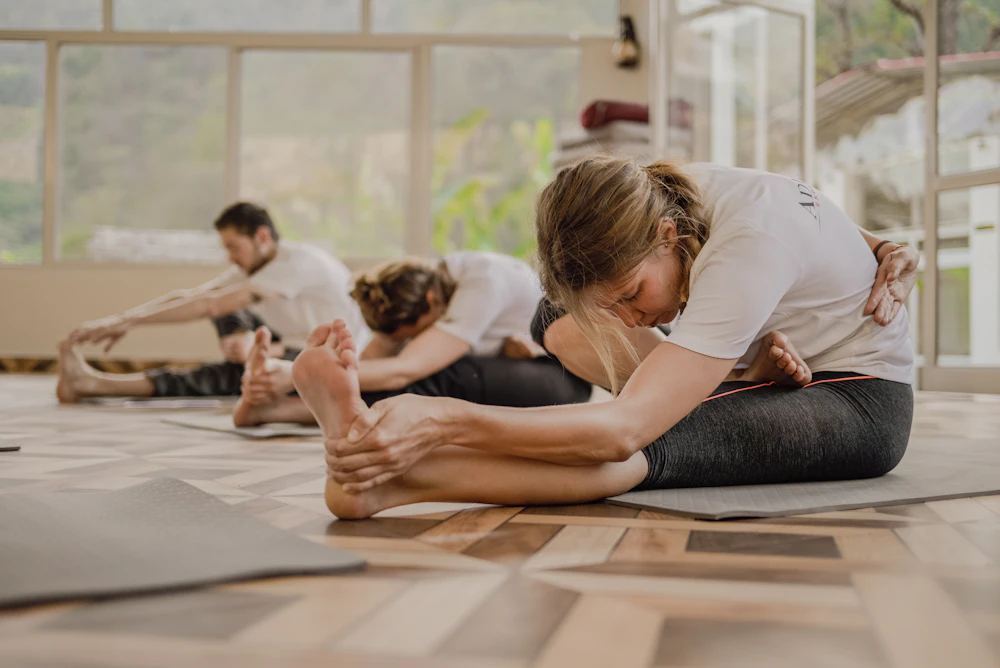 Small group meditation circle in a bright, plant-filled office loft